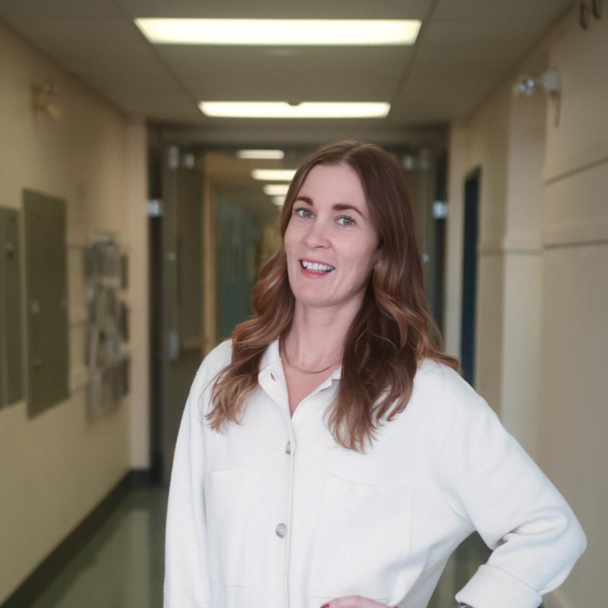 Shauna stands in the hallway