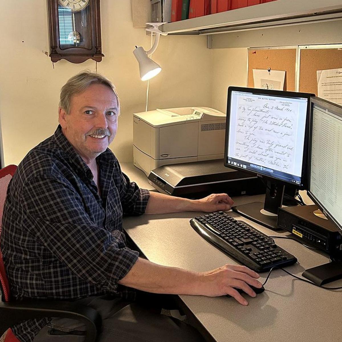 Stephen sits at his computer