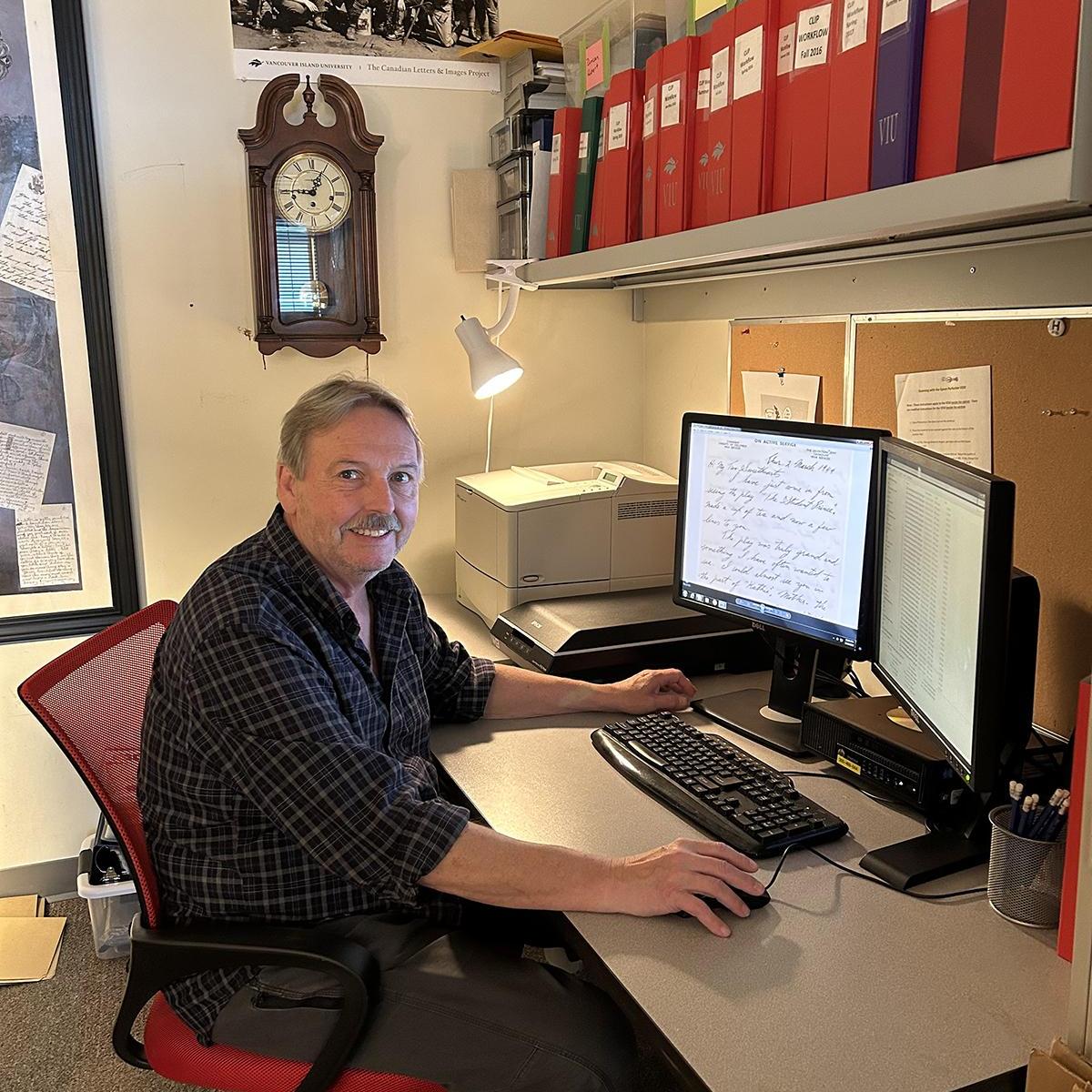 Stephen sits at his computer