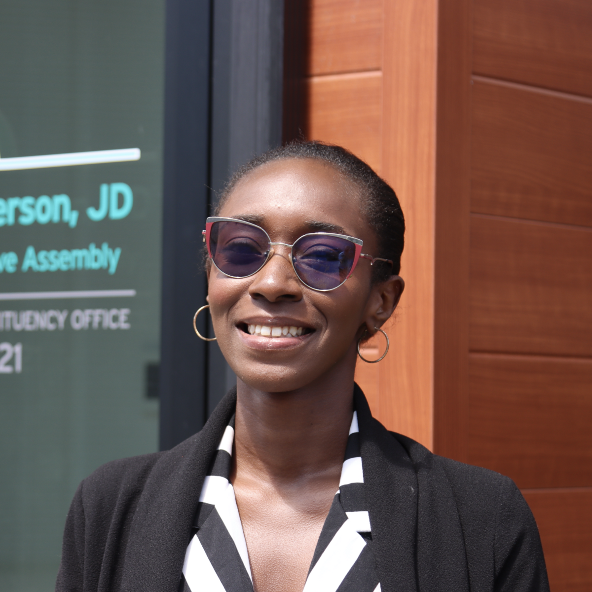 Awula standing outside George Anderson's office and smiling at the camera.