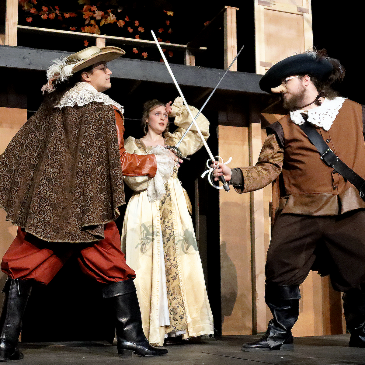 Three of the actors stage a swordfighting scene for their production Cyrano de Bergerac.