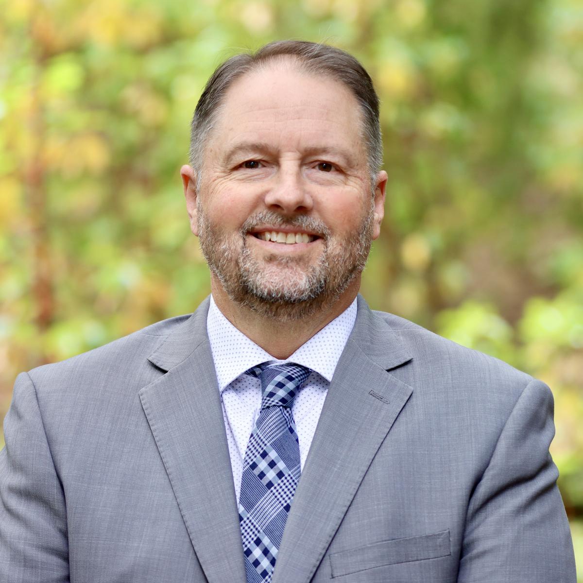 Dennis Johnson with a forest background