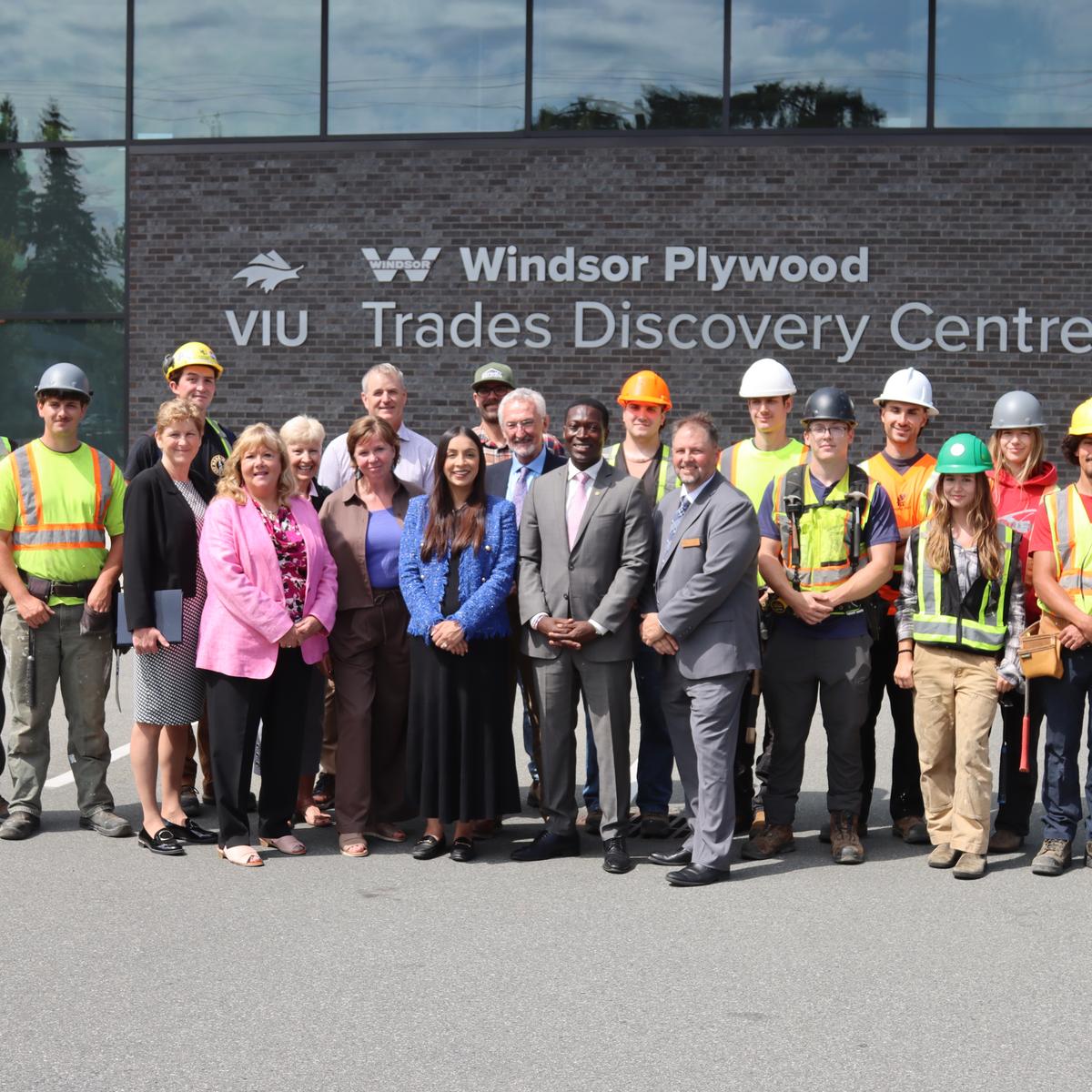 A group of students staff and politicians standing in front of the VIU Trades Discovery centre