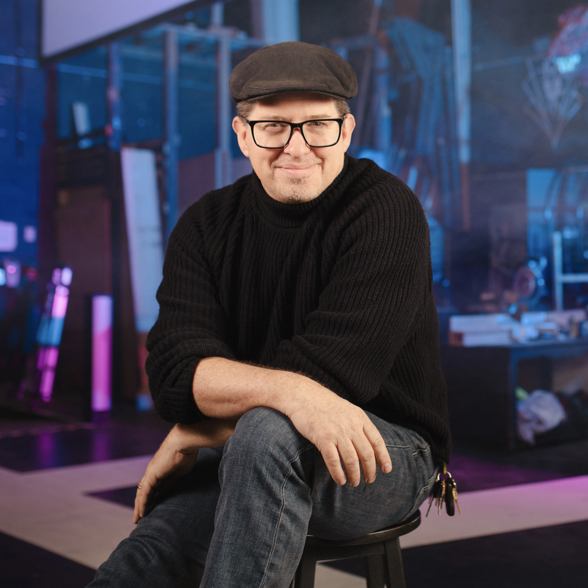 Leon Potter sitting on the stage and smiling at the camera.