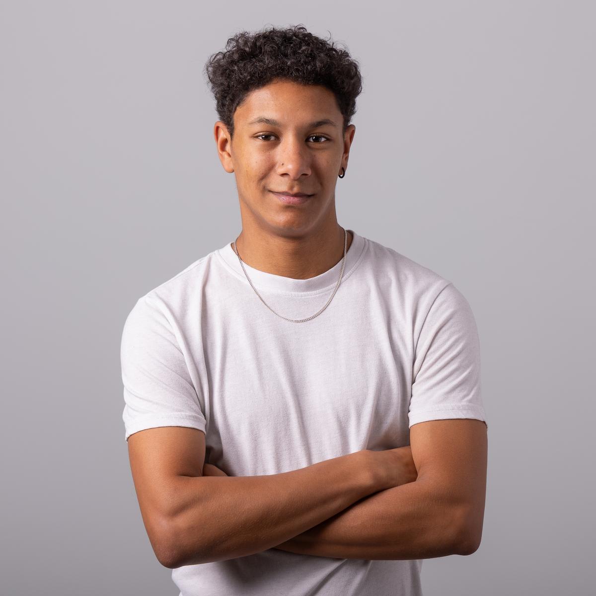 Michael Joseph standing with his arms crossed and smiling at the camera.