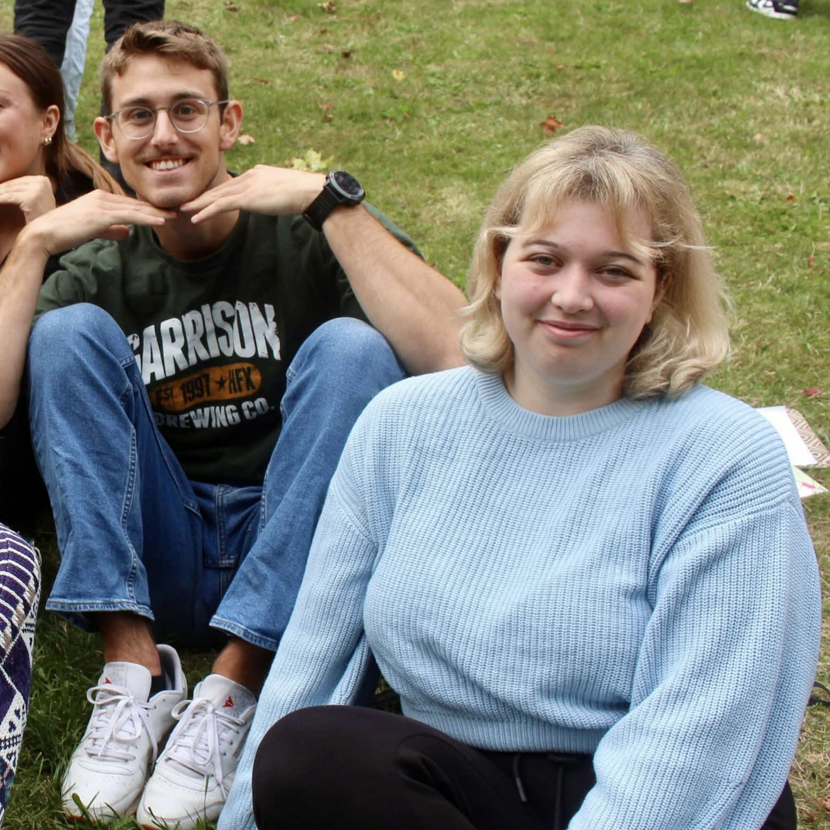 victoria dudley sitting outside with a group of her friends