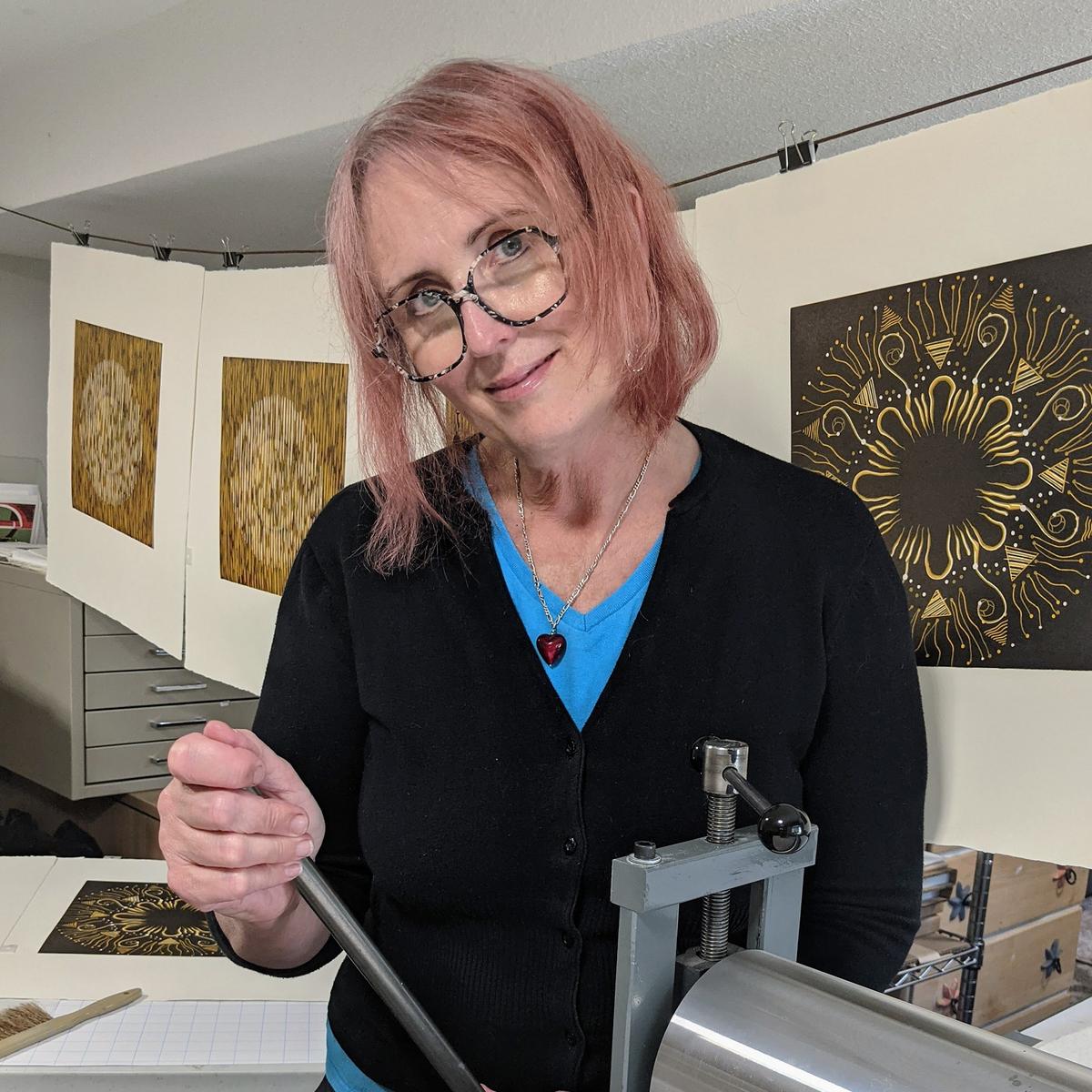 Mary Anne Molcan stands by her print press.