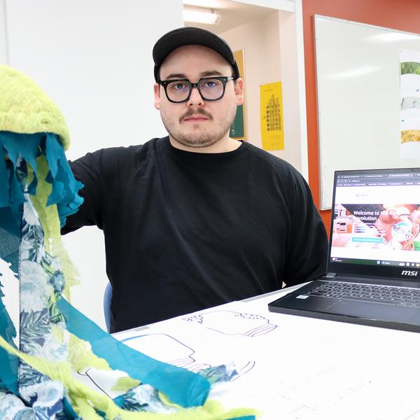 James Reilly holds up an octopus made out of fabric.