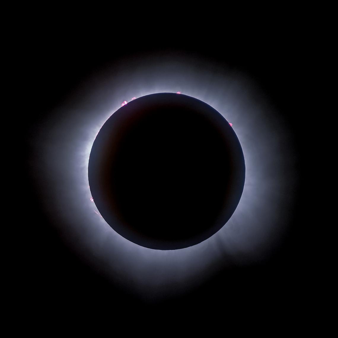 Total solar eclipse with a ring of glowing solar around the Moon's disk.