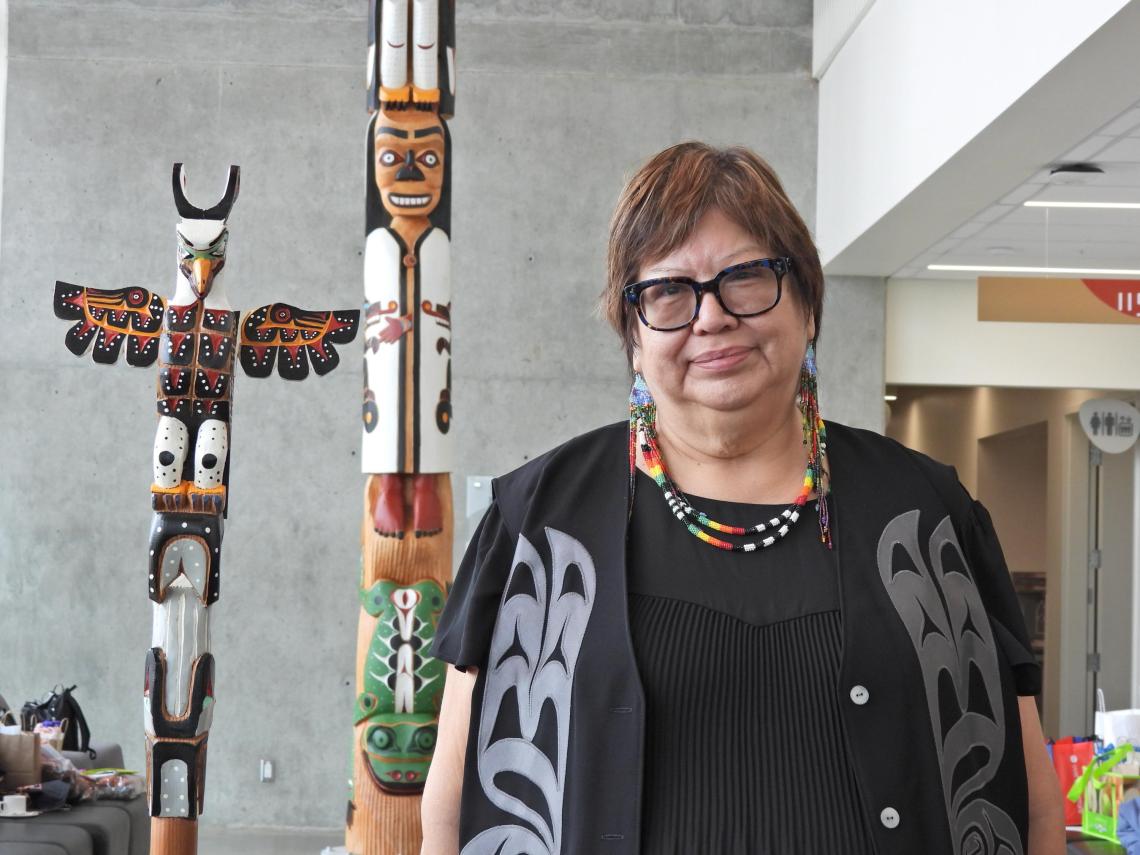 VIU Chancellor with Talking Stick and totem in VIU Centre for Health and Science