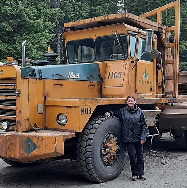 Jennifer Lindley stands next to a forestry truck