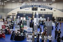 Aerial view of VIU gym with lots of booths and people milling about