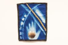 A cyanotype print with a hand, small shells and a seashell.