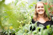 Profile of Bianca van der Stoel in a greenhouse surrounded by plants