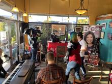 People doing a live broadcast in a coffee shop