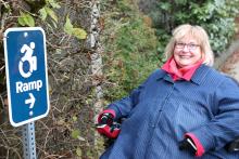 Dr. Linda Derksen with a ramp sign