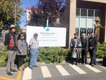 Group photo around the new sign at VIU’s campus in the qathet region 