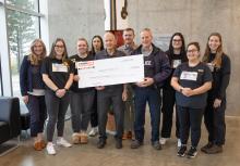 Nursing students pose with a big cheque with Gary O'Brien from Nanaimo RCMP