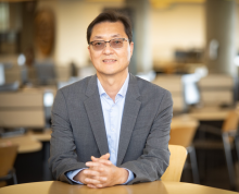 Dr. Sungchul Cho sitting at a desk and smiling at the camera.