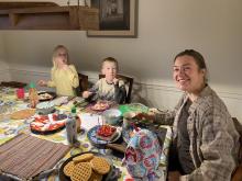 A breakfast table with two children and a female adult