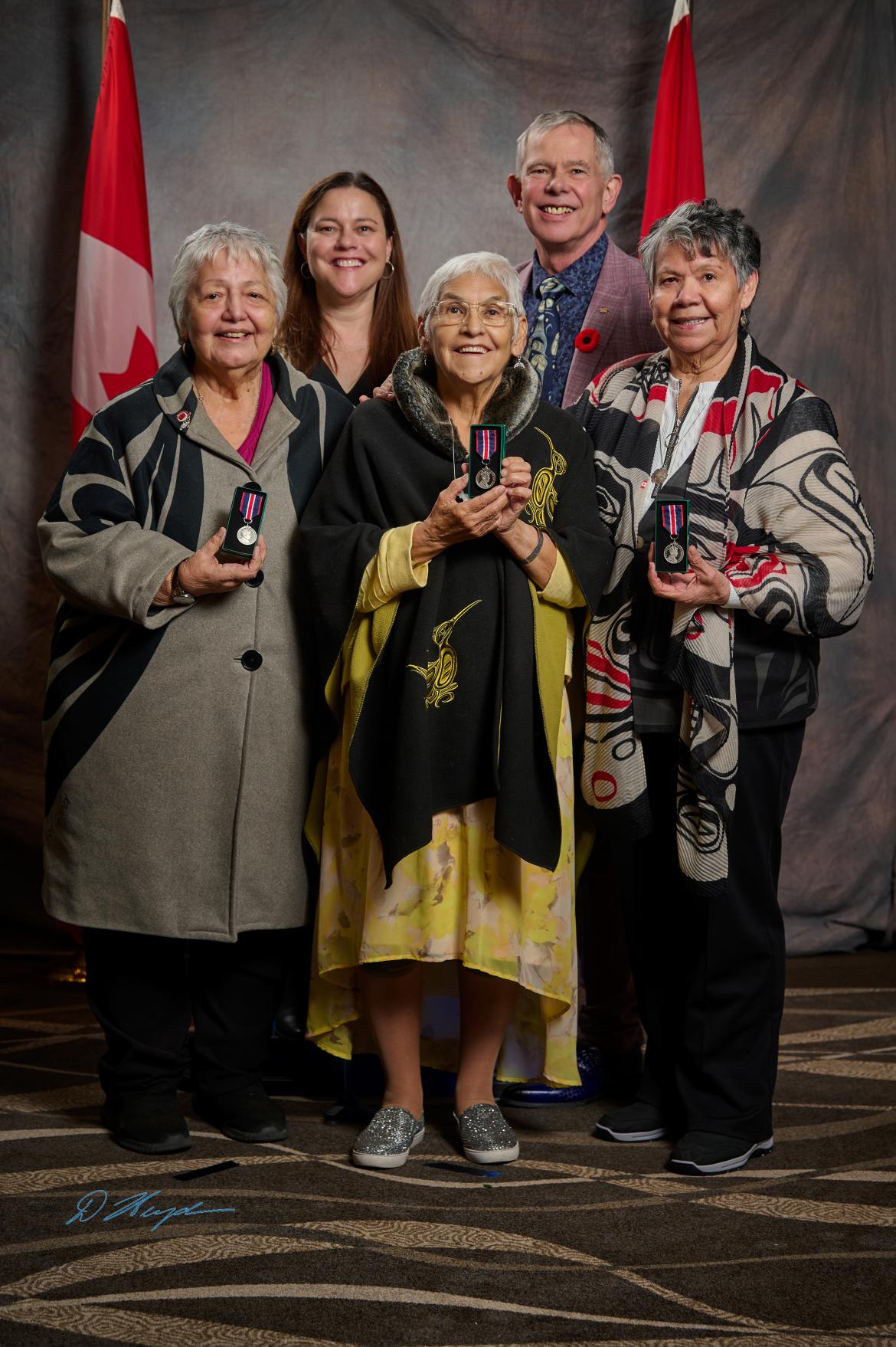 group of people holding awards