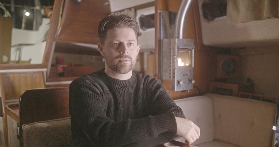Bryce Casavant sits in the interior of a boat