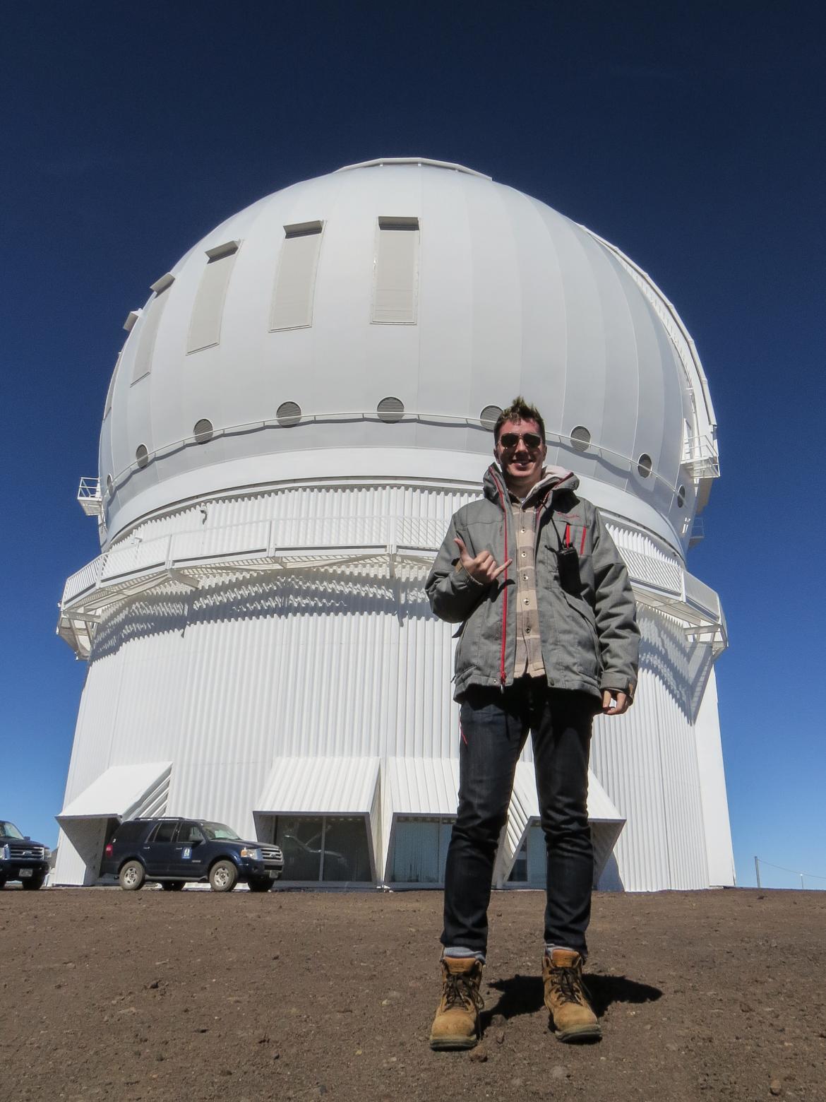 Cam Wipper in front of the Canada-France-Hawaii Telescope