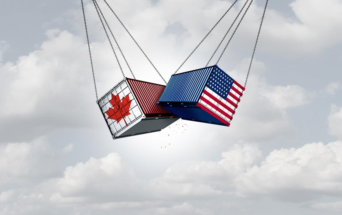 Two freight containers swinging into each other, one has the Canada flag, the other has the United States flag