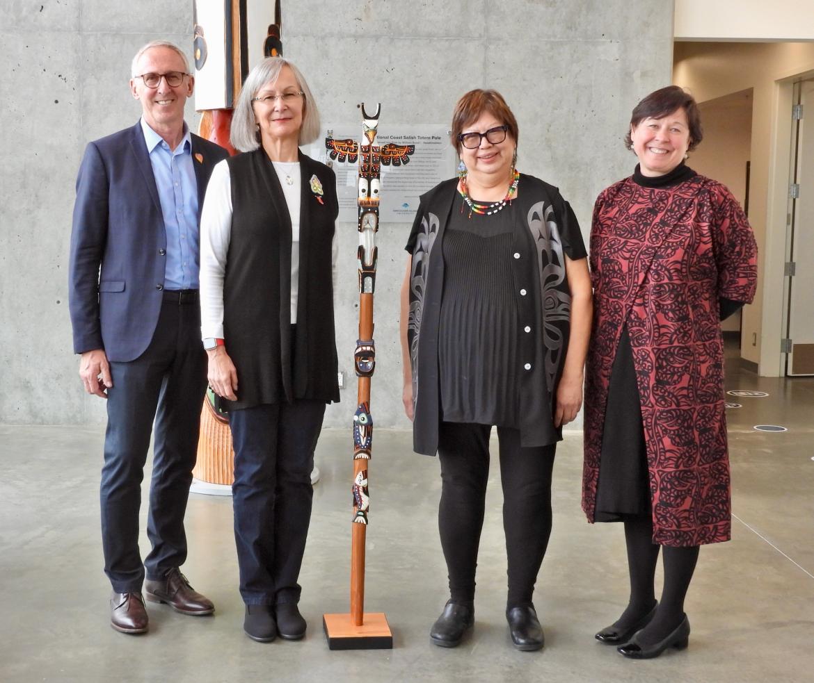 VIU and UVic Presidents and Chancellors pose with the Talking Stick