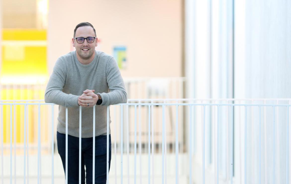 Man leans on railing in VIU's Centre for Health and Science