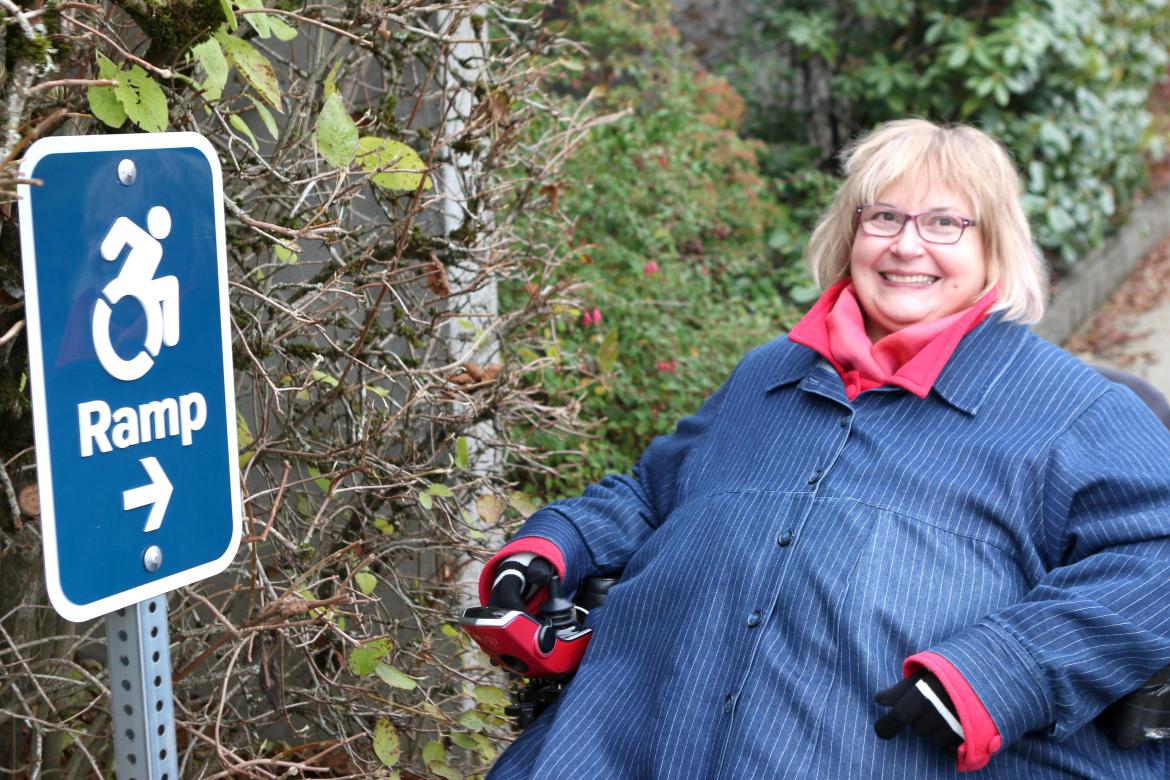 Dr. Linda Derksen with a ramp sign