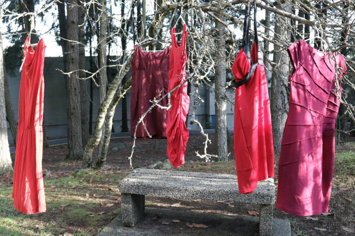 Red Dresses hang on a tree branches