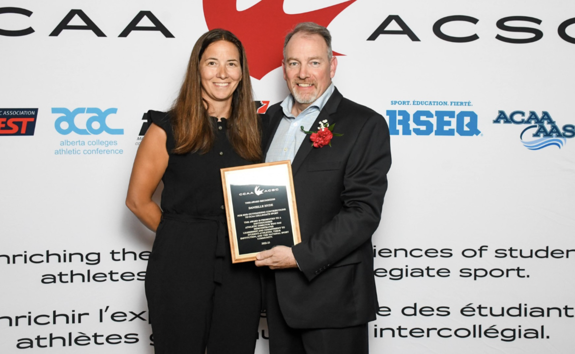 Danielle Hyde on the left receiving her award from a CCAA representative