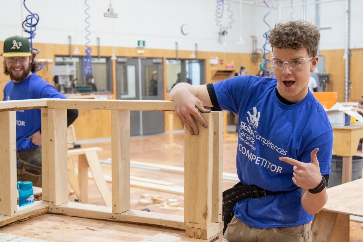 Two carpentry students work on a project