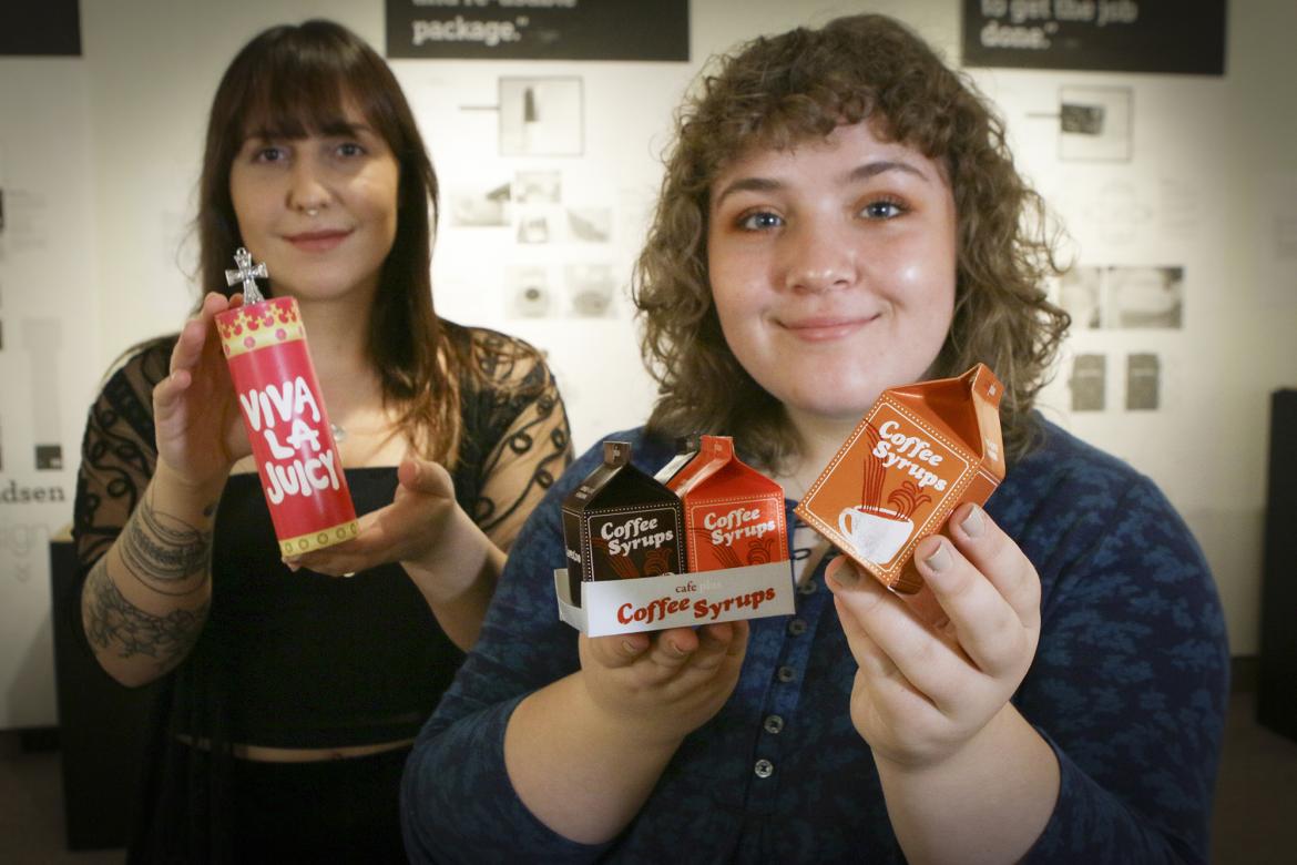Rebecca Hanelt, left, and Chantelle Calitz, VIU Graphic Design students, showcase their environmentally sustainable packaging redesigns during the art exhibit Unwrapped at The View Gallery. 
