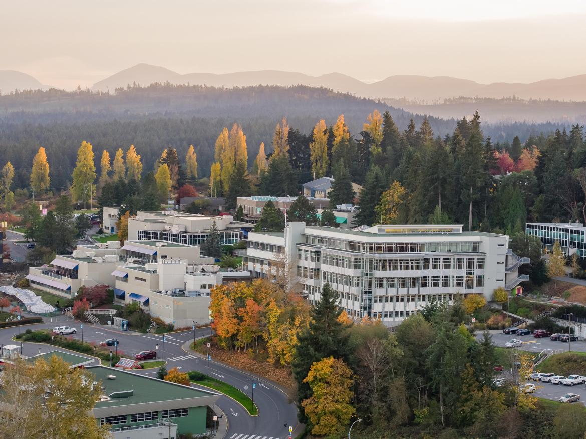 An aerial view of VIU's Nanaimo campus during the fall trees dappled with yellow and orange leaves.
