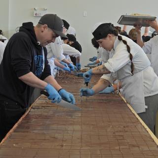 Students cut the large Nanaimo bar