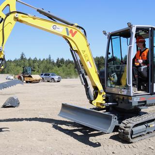 a person operates an excavator