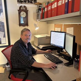 Stephen sits at his computer