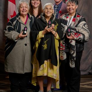 group of people holding awards