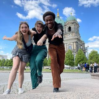 three students run at the camera