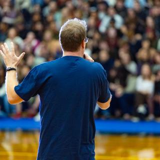 Emcee Matt Carter welcoming new students in the gym