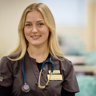 Christina smiling at the camera while wearing a VIU Nursing shirt.