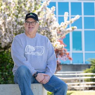 David Butler sitting outside on a sunny day.