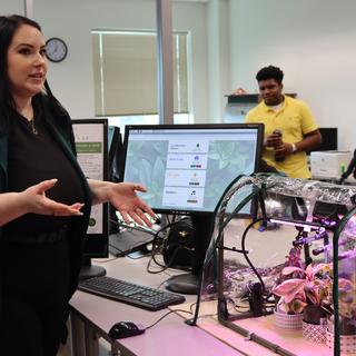 a student at the ITAS fair showing and talking abut their project