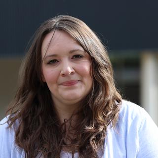 Laci standing outside and smiling at the camera