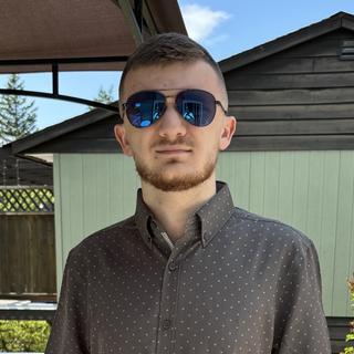 Zackary Sutton outside wearng sunglasses and looking at the camera