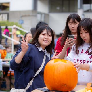 students carve a pumpkin