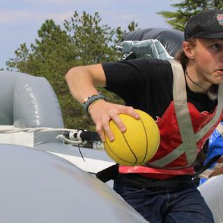 A student runs with a ball
