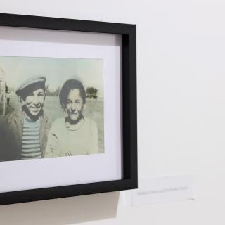 Atticus Mercredi's family photos on the View Gallery's wall.